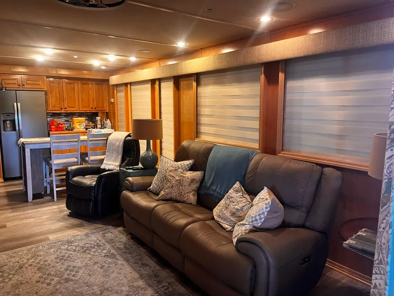 Slide: The Image of Modern RV interior with leather sofa, kitchen island, and wooden cabinets, Starlight 68X16, 2004 model. - 3