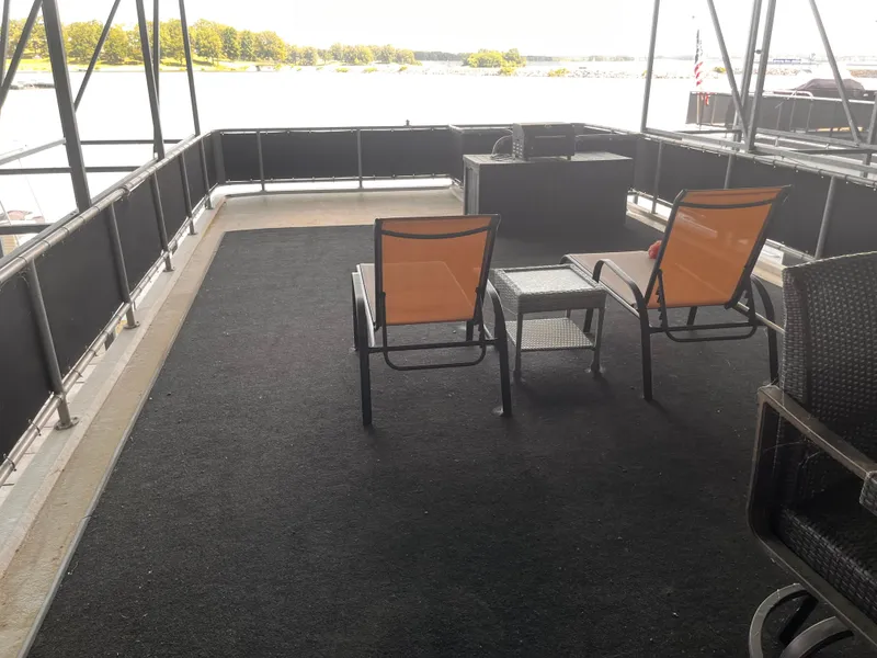 Slide: The Image of Upper deck of 2004 Starlight 68X16 houseboat with chairs and table, overlooking water. - 32