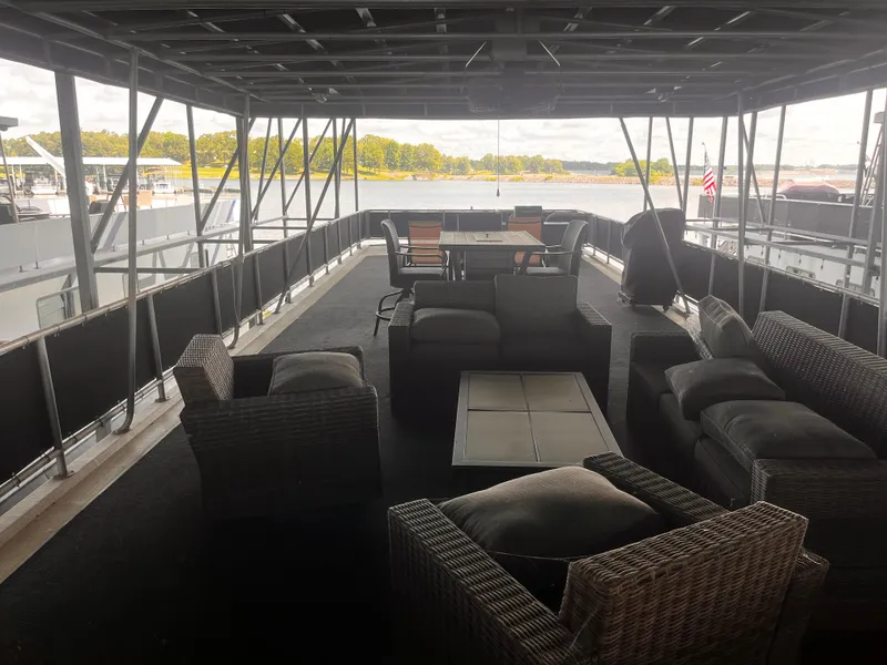 Slide: The Image of Spacious deck of a 2004 Starlight 68X16 houseboat with outdoor seating and lake view. - 33