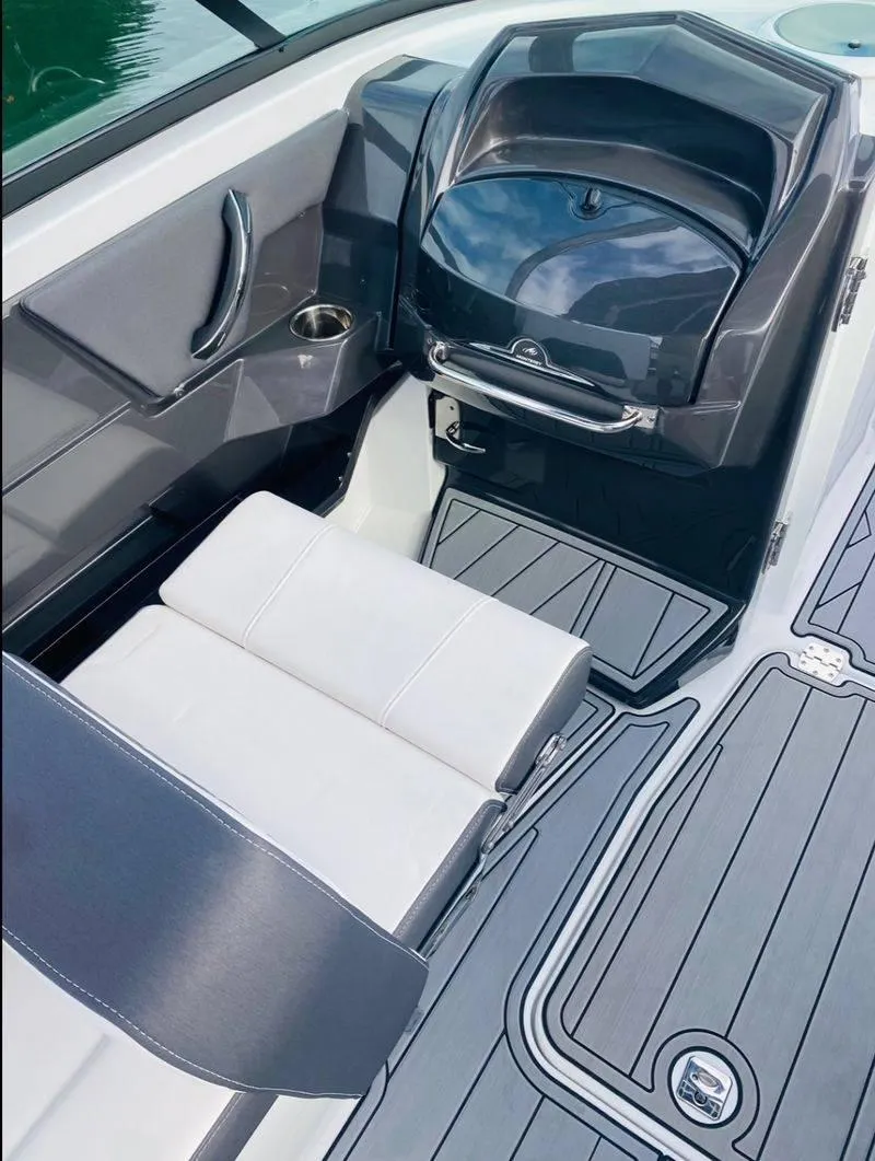 Slide: The Image of 2023 Monterey 298SS boat interior with white seating and gray flooring. - 10