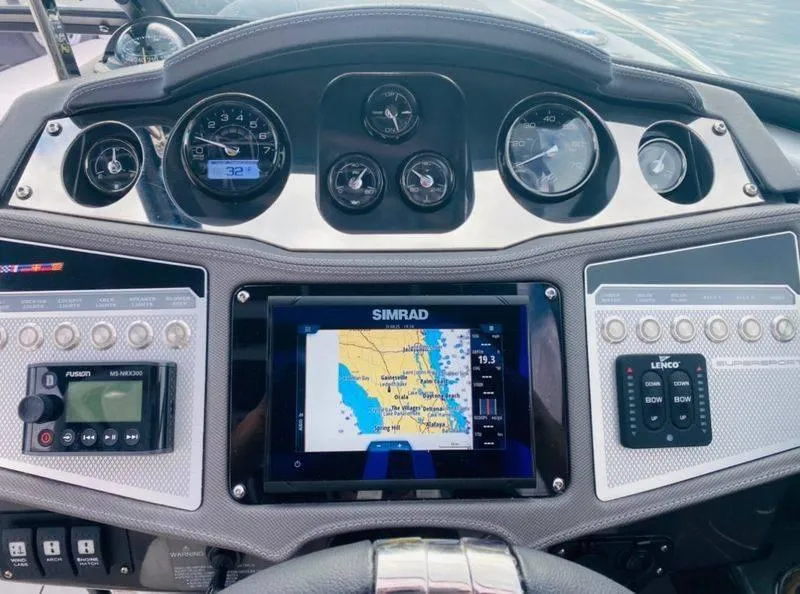 Slide: The Image of 2023 Monterey 298SS boat dashboard with Simrad navigation system and control panels. - 11