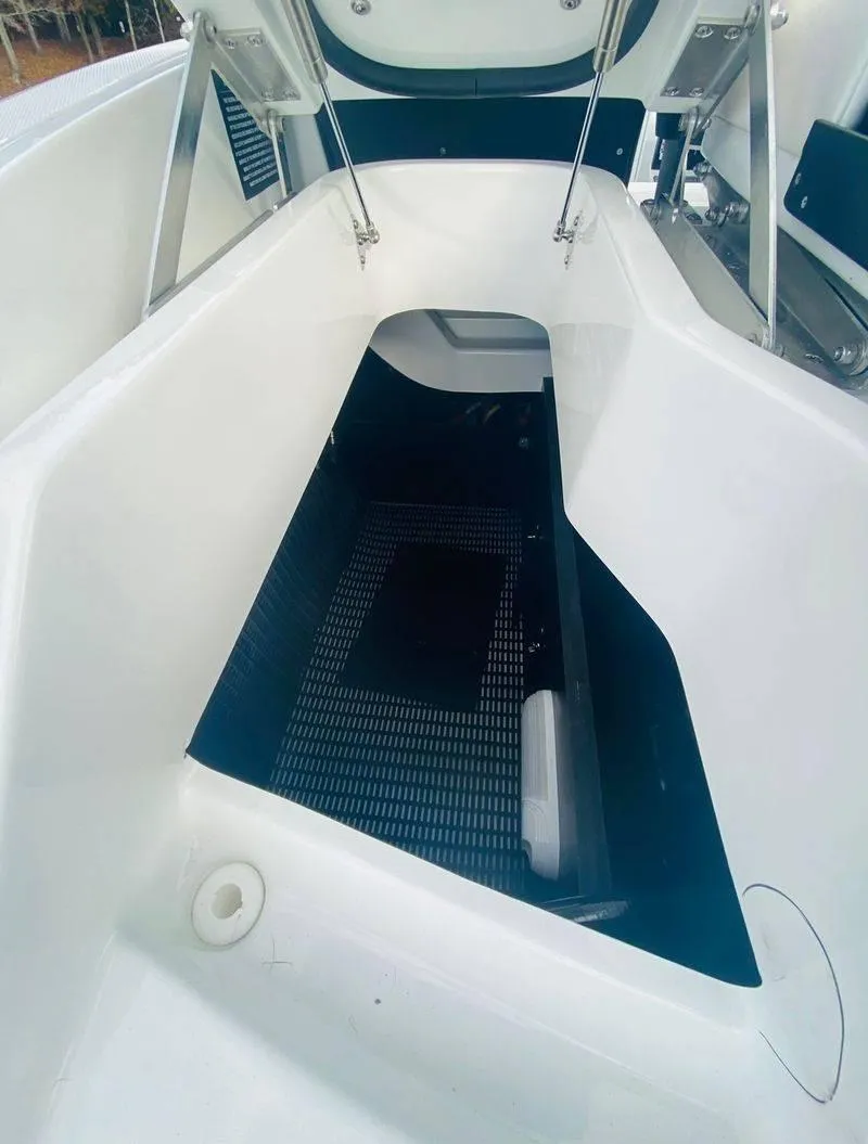 Slide: The Image of 2023 Monterey 298SS boat storage compartment with open hatch. - 14