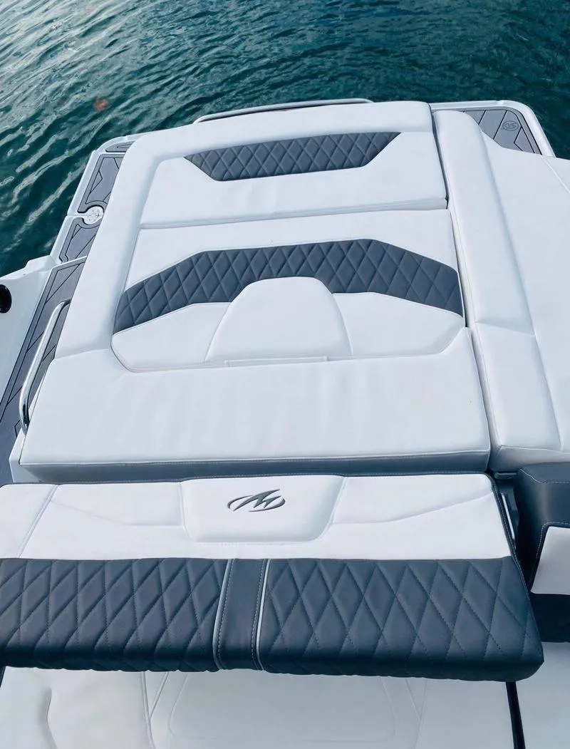 Slide: The Image of 2023 Monterey 298SS boat with luxurious white and gray seating. - 19