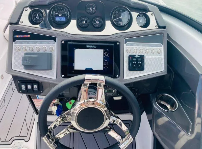 Slide: The Image of 2023 Monterey 298SS boat dashboard with steering wheel, gauges, and Simrad display. - 4