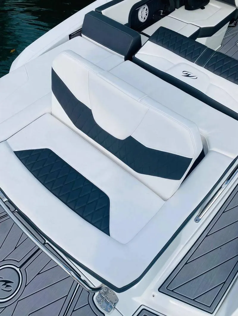 Slide: The Image of 2023 Monterey 298SS boat with white and black cushioned seating. - 7