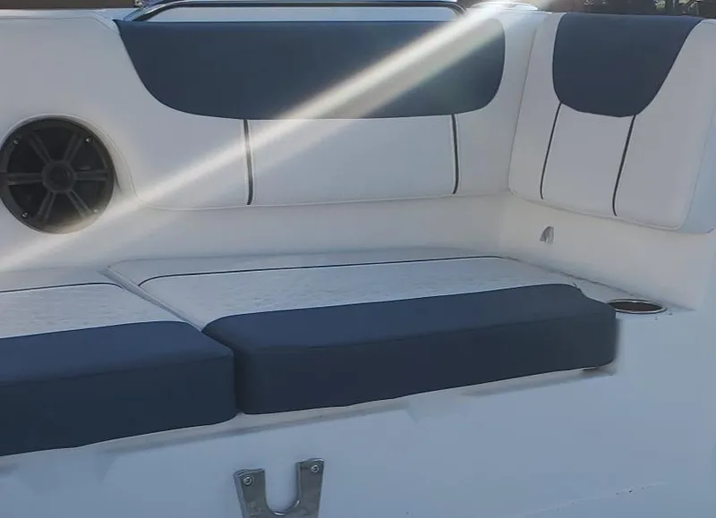 Slide: The Image of 2024 Tahoe 2150 boat interior with cushioned seating and speaker. - 5