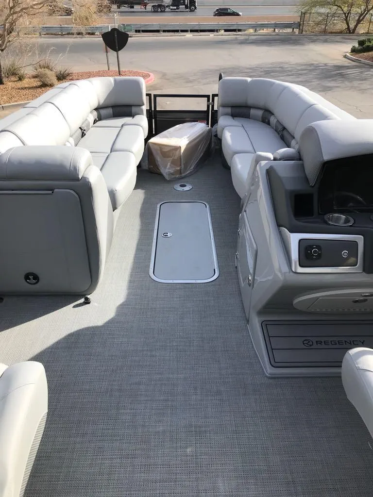 Slide: The Image of 2024 Regency 250 LE3 pontoon boat with spacious seating and modern design. - 10