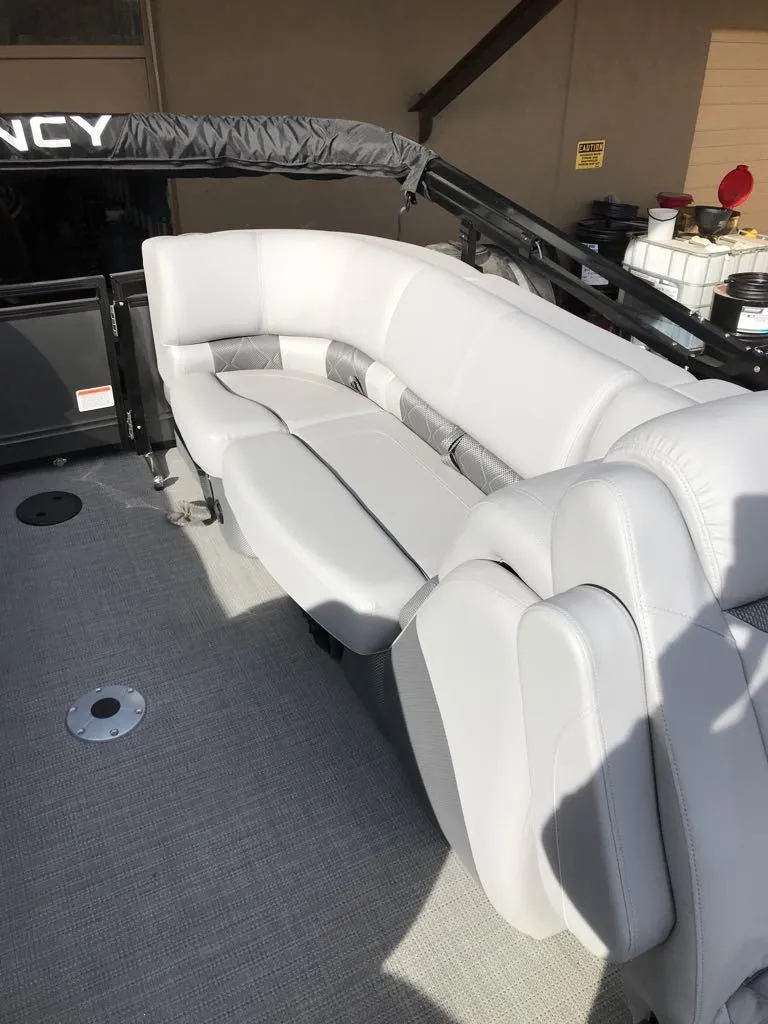 Slide: The Image of 2024 Regency 250 LE3 boat interior with plush seating and modern design. - 12