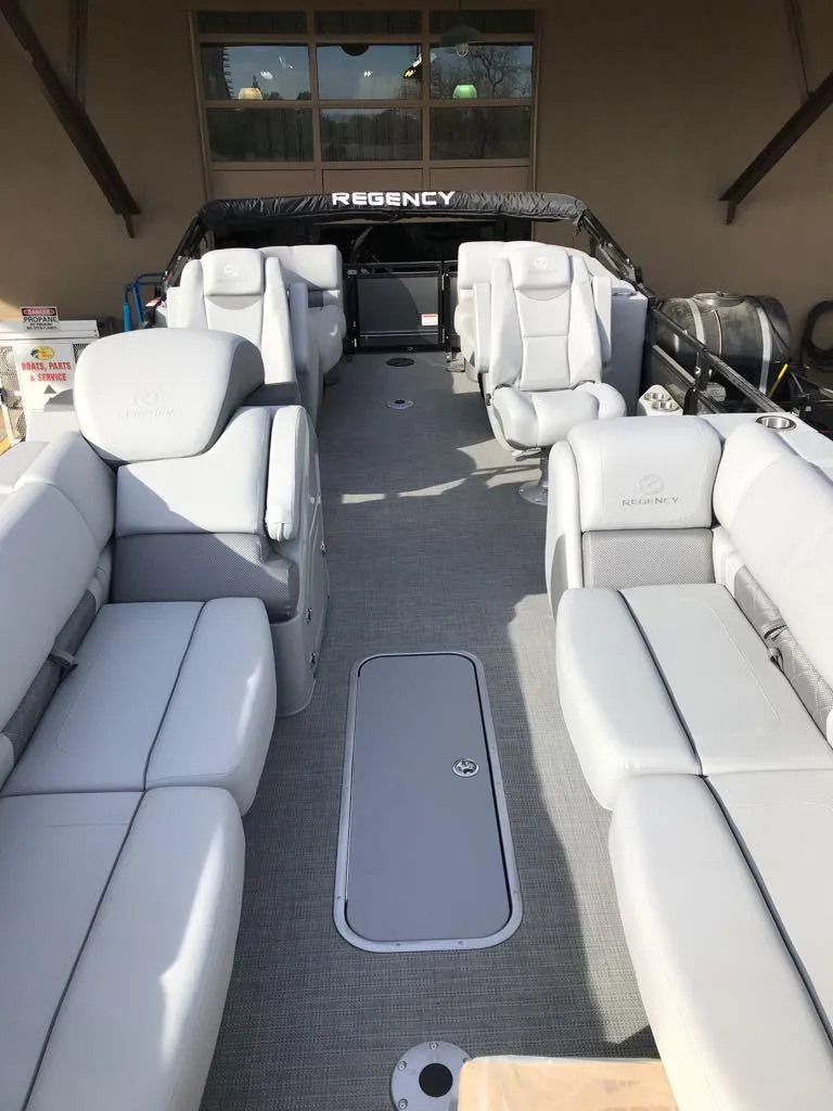 Slide: The Image of 2024 Regency 250 LE3 pontoon boat with spacious seating and modern design. - 7