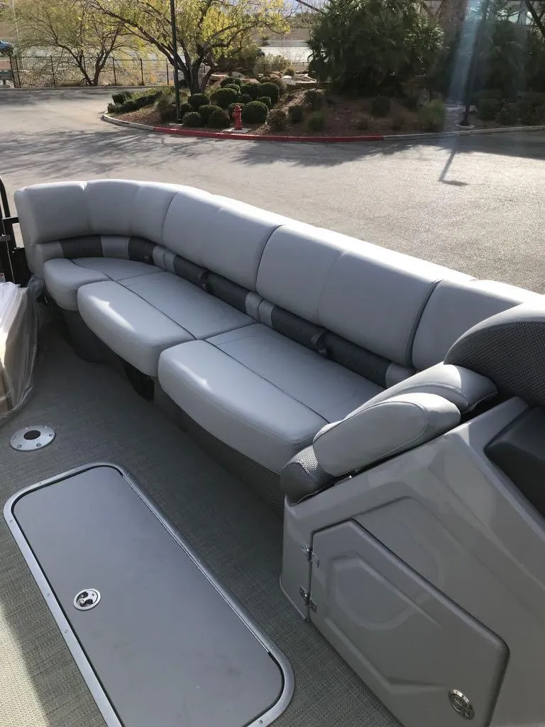 Slide: The Image of 2024 Regency 250 LE3 boat with spacious, cushioned seating in a serene outdoor setting. - 8