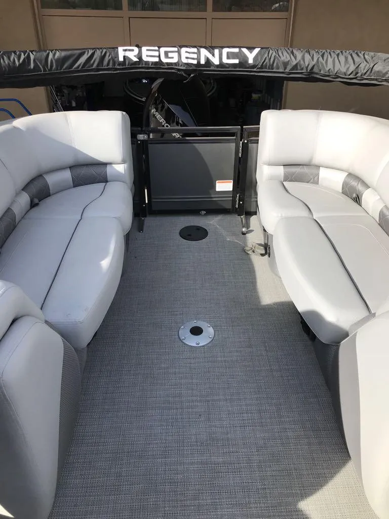 Slide: The Image of 2024 Regency 250 LE3 pontoon boat interior with plush seating and modern design. - 9