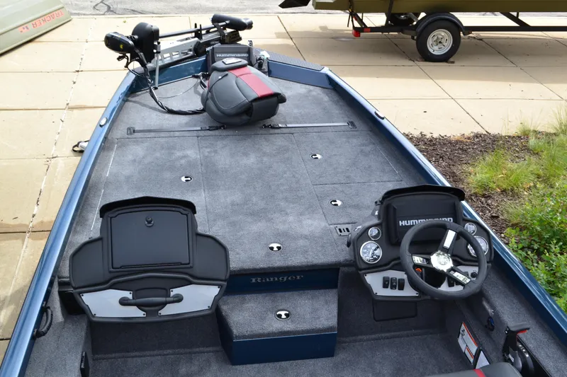 Slide: The Image of 2024 Ranger RT198P fishing boat interior with steering console and seating. - 2
