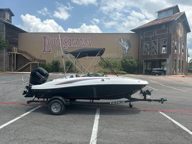 Slide: The Image of 2024 Tahoe T16 boat on trailer in Louisiana parking lot. - 2