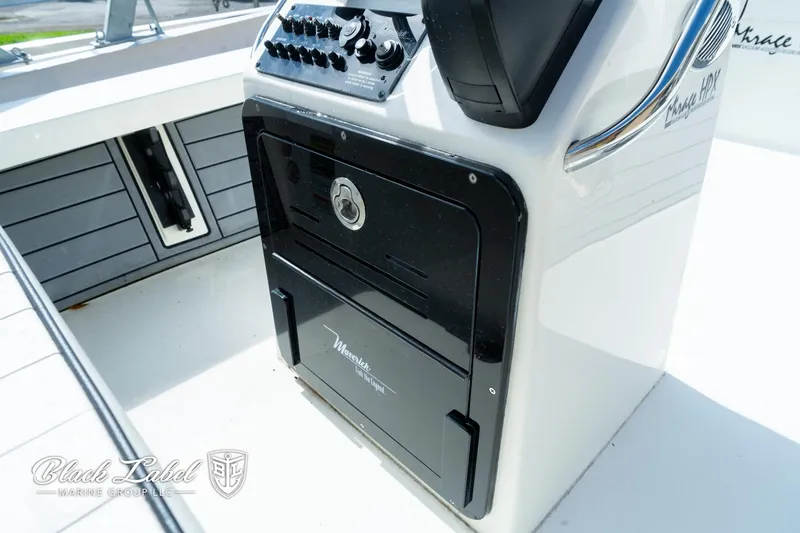 Slide: The Image of 2024 Maverick HPX-S 17 boat console with control panel and storage compartment. - 17