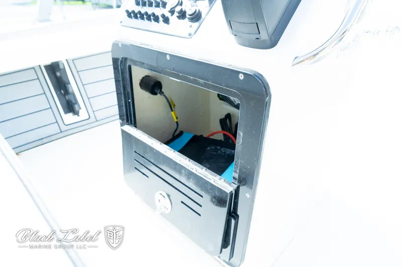 Slide: The Image of Open storage compartment on a 2024 Maverick HPX-S 17 boat console. - 18