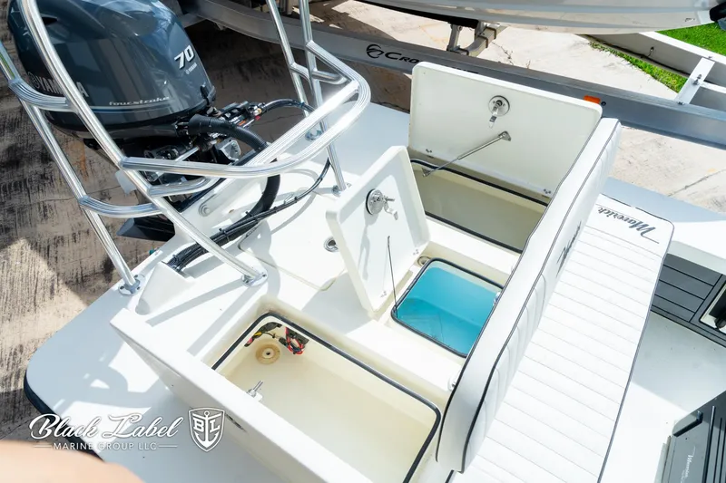 Slide: The Image of 2024 Maverick HPX-S 17 boat with open storage compartments and Yamaha 70 engine. - 20