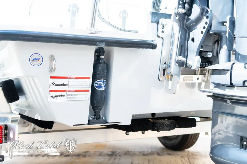 Slide: The Image of 2024 Maverick HPX-S 17 boat transom with hydraulic components and safety labels. - 6