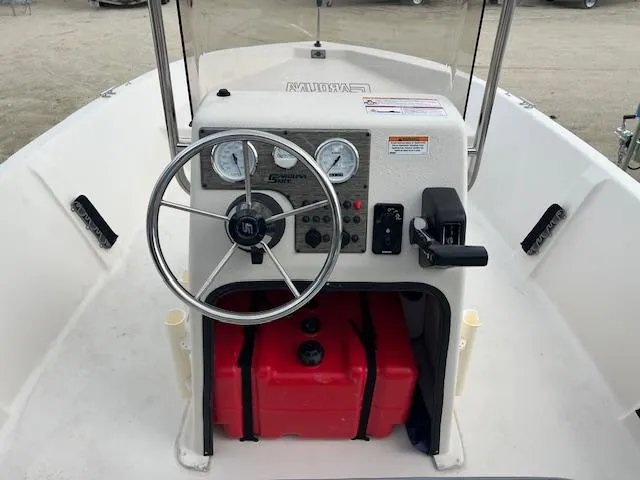 Slide: The Image of 2024 Carolina Skiff EV218 Sea Skiff boat console with steering wheel and gauges. - 5