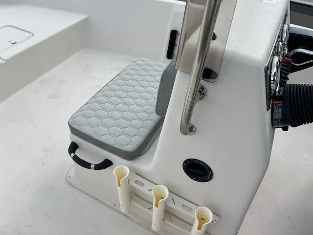 Slide: The Image of 2024 Carolina Skiff EV218 Sea Skiff console seat with rod holders and steering controls. - 6