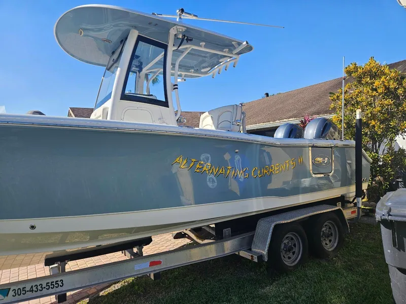 Slide: The Image of 2021 Sea Hunt Gamefish 25 boat on trailer, named Alternating Currents II. - 12