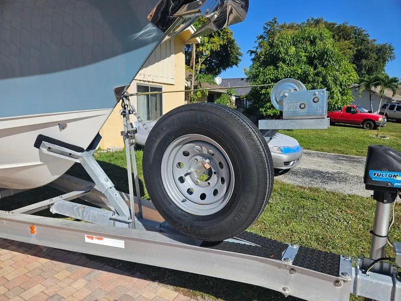 Slide: The Image of 2021 Sea Hunt Gamefish 25 boat on trailer with spare tire. - 17