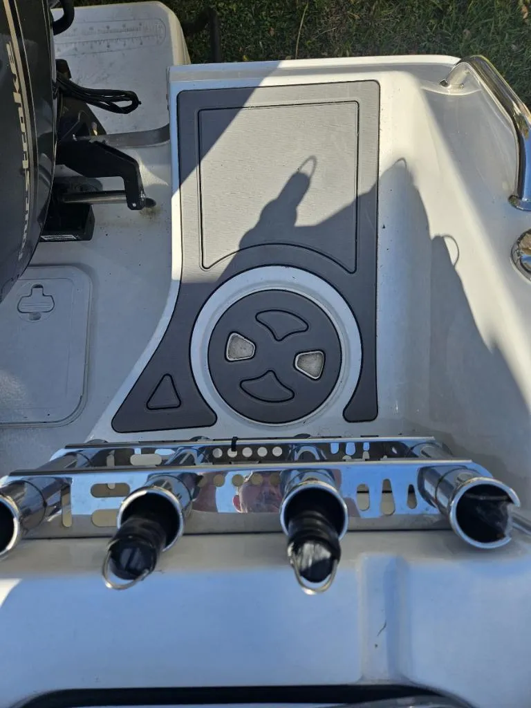 Slide: The Image of 2021 Sea Hunt Gamefish 25 boat deck with rod holders and storage compartment. - 21