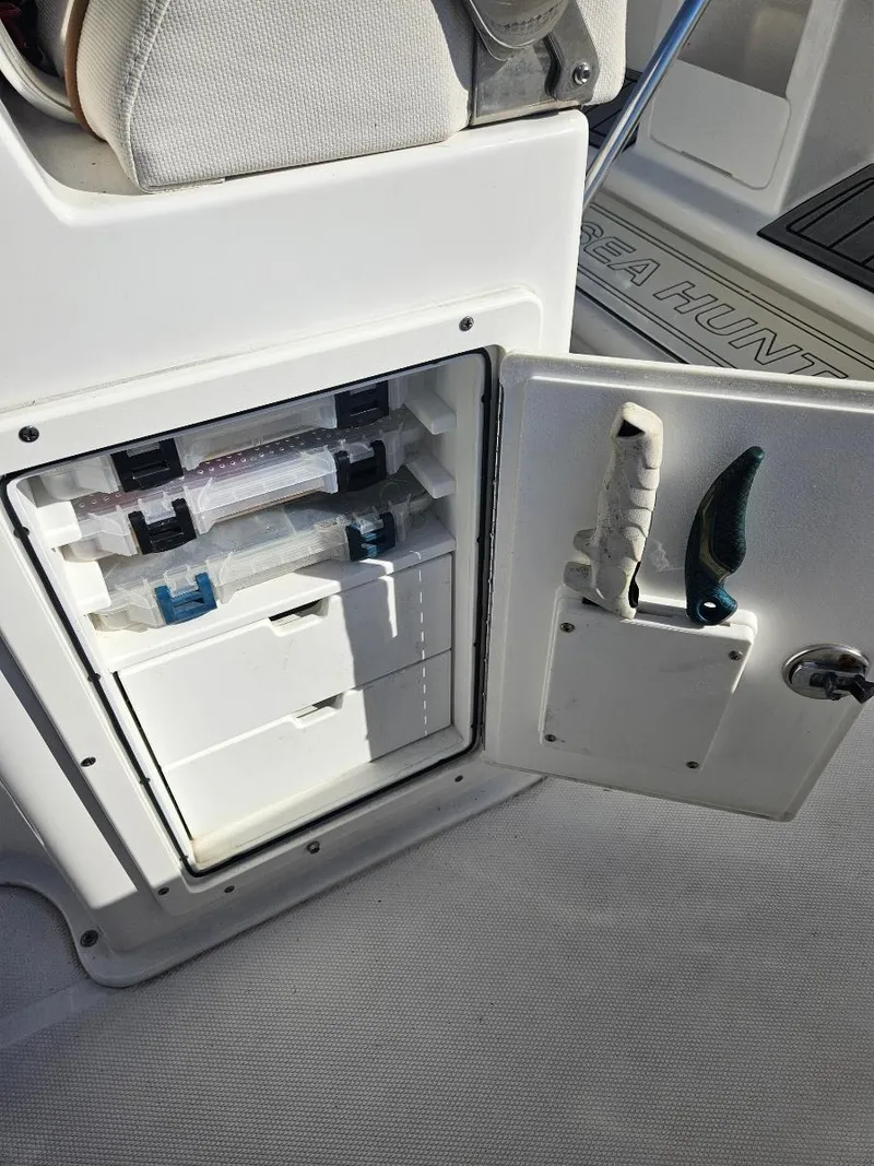 Slide: The Image of Open storage compartment on a 2021 Sea Hunt Gamefish 25 boat. - 25