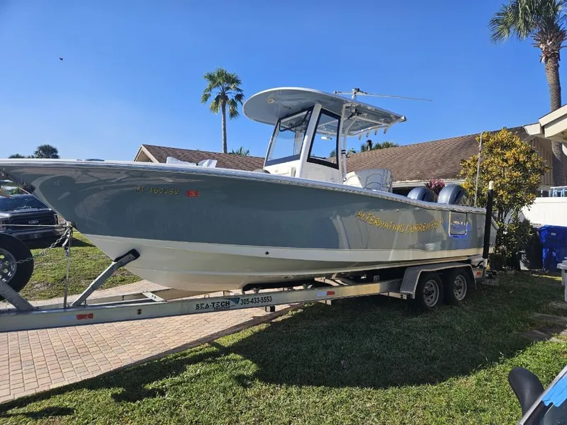 The Image of 2021 Sea Hunt Gamefish 25 boat on a trailer in a residential area. - 7