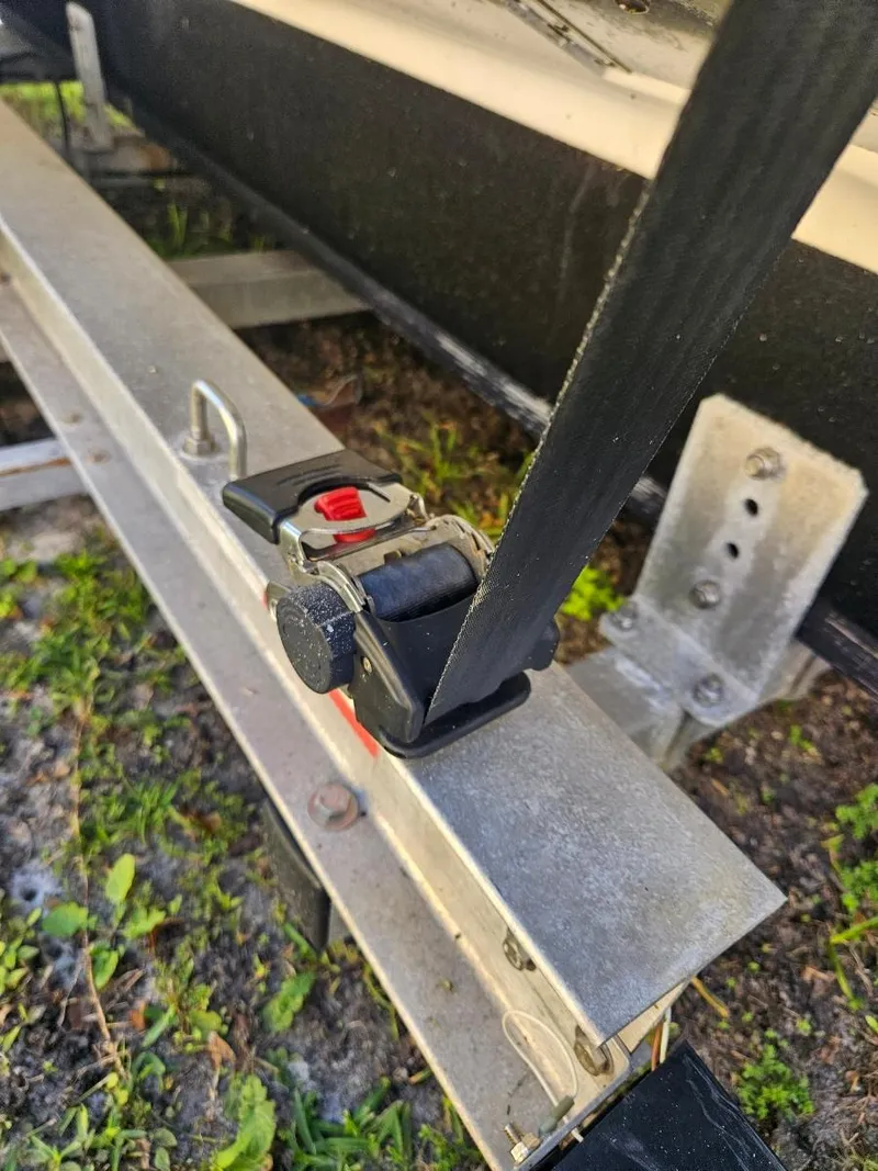 Slide: The Image of Close-up of a 2021 Sea Hunt Gamefish 25 boat trailer strap and ratchet. - 9