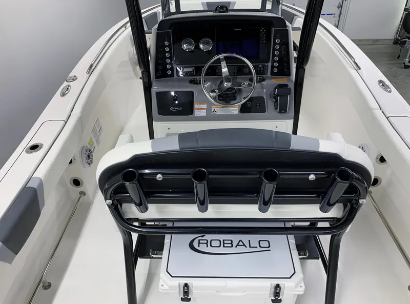 Slide: The Image of 2024 Robalo R232 Explorer boat cockpit with steering wheel and control panel. - 17