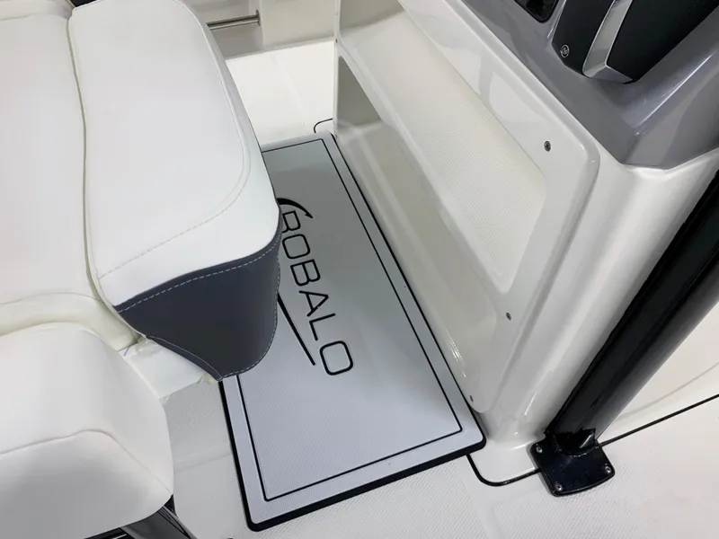 Slide: The Image of 2024 Robalo R232 Explorer boat interior with branded floor mat and seating. - 21