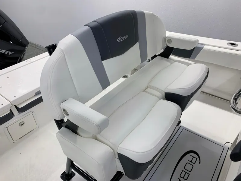 Slide: The Image of Robalo R232 Explorer 2024 boat seating with white and gray upholstery. - 22