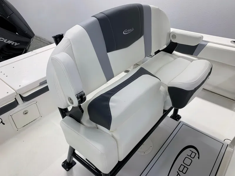 Slide: The Image of 2024 Robalo R232 Explorer boat seating with white and gray upholstery. - 23