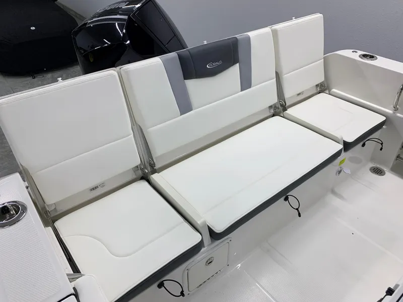 Slide: The Image of 2024 Robalo R232 Explorer boat seating area with white cushioned seats. - 25