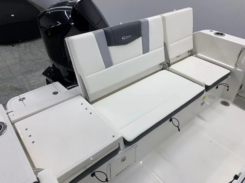 Slide: The Image of 2024 Robalo R232 Explorer boat seating area with white and gray cushions. - 26