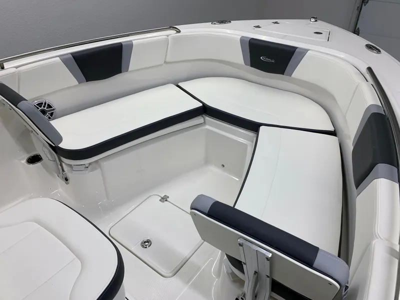 Slide: The Image of 2024 Robalo R232 Explorer boat interior with white and black cushioned seating. - 27