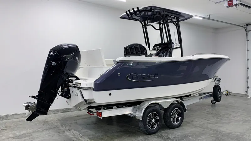 Slide: The Image of 2024 Robalo R232 Explorer boat on trailer in garage. - 3