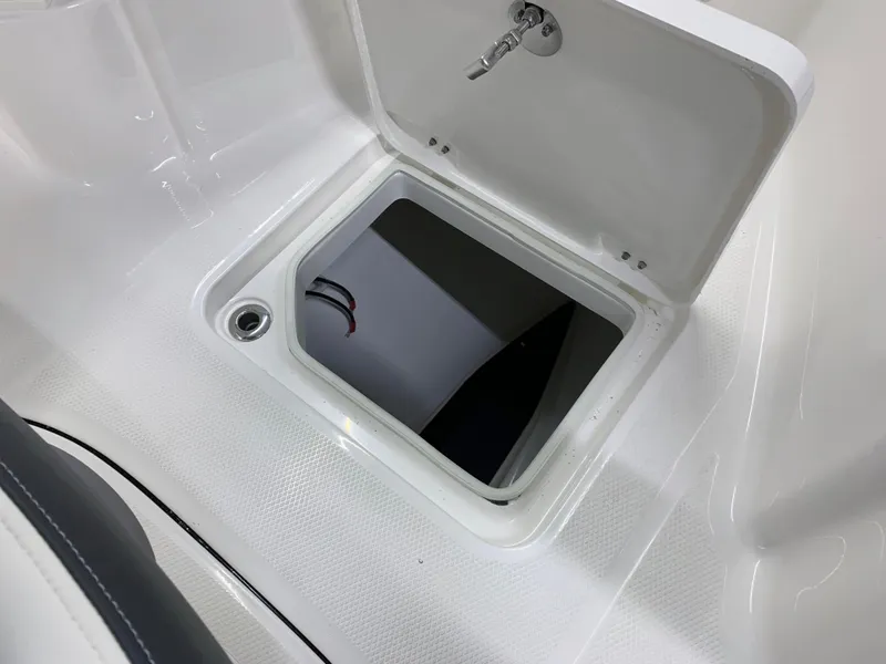 Slide: The Image of 2024 Robalo R232 Explorer storage compartment with open hatch. - 33