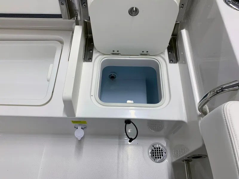 Slide: The Image of 2024 Robalo R232 Explorer boat livewell and storage compartments. - 37