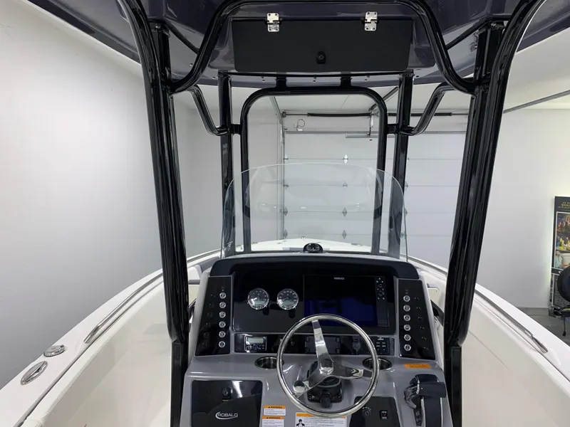 Slide: The Image of 2024 Robalo R232 Explorer boat console with steering wheel and navigation controls. - 38