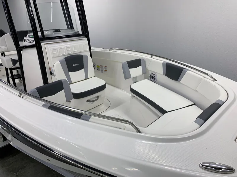 Slide: The Image of 2024 Robalo R232 Explorer boat interior with cushioned seating and modern design. - 4