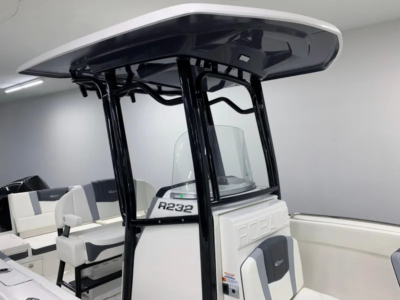 Slide: The Image of 2024 Robalo R232 Explorer boat interior with T-top and seating. - 6
