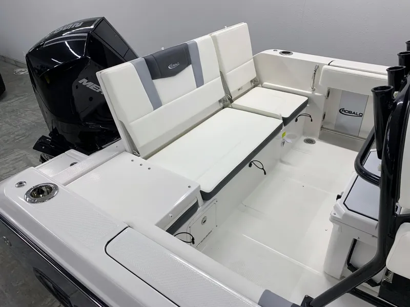 Slide: The Image of 2024 Robalo R232 Explorer boat interior with seating and outboard motor. - 9