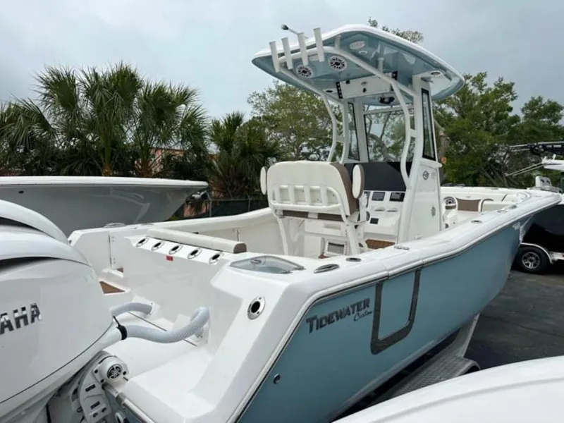 Slide: The Image of 2024 Tidewater 256 CC Adventure boat with Yamaha engine, docked outdoors. - 3