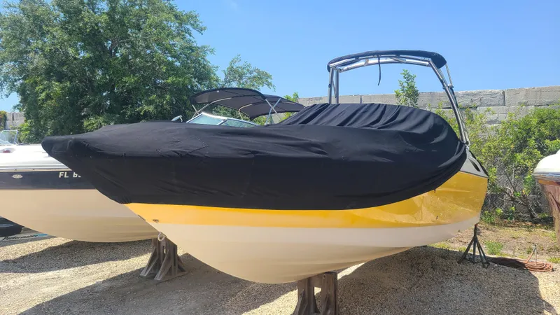 The Image of 2004 Monterey 268 SS Open Bow Sport boat with black cover, parked on stands. - 0