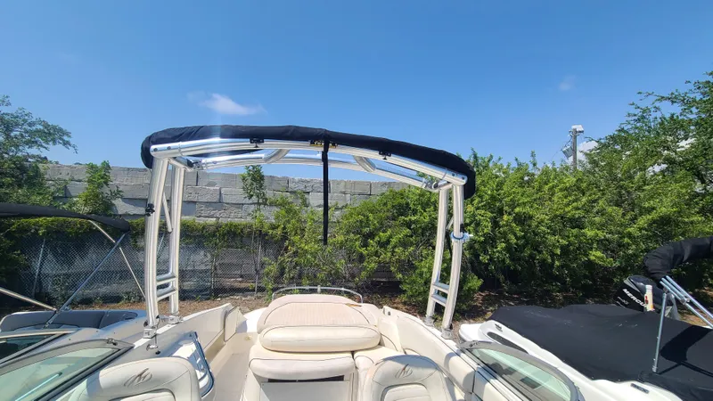 Slide: The Image of 2004 Monterey 268 SS Open Bow Sport boat with bimini top, parked outdoors. - 13