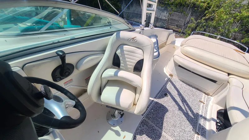 Slide: The Image of 2004 Monterey 268 SS Open Bow Sport boat interior with white seating and steering wheel. - 15