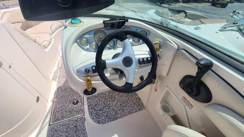 Slide: The Image of 2004 Monterey 268 SS Open Bow Sport boat cockpit with steering wheel and control panel. - 16