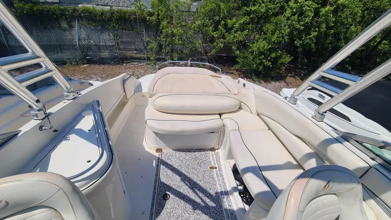 Slide: The Image of 2004 Monterey 268 SS Open Bow Sport boat interior with white seating and open layout. - 18