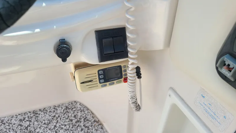 Slide: The Image of 2004 Monterey 268 SS Open Bow Sport boat dashboard with radio and controls. - 21